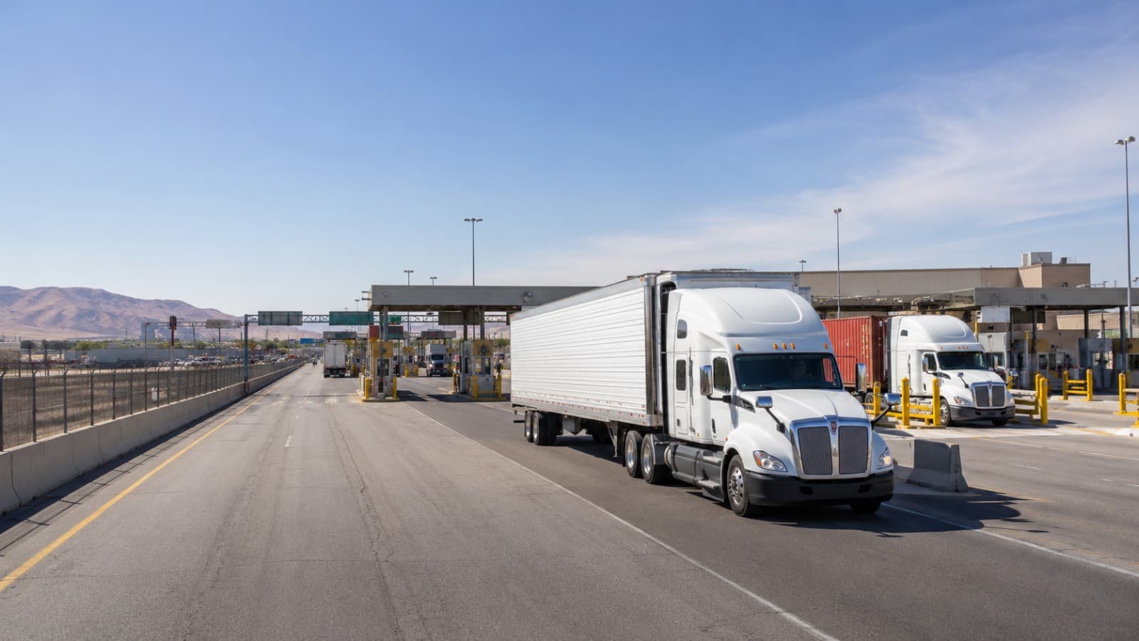 Tractor-trailer pulling into a US-Mexico land port of entry inspection plaza
